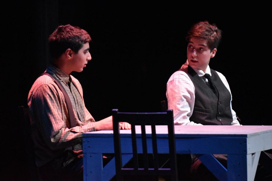 Raphael Sanche (12), in the role of Dr. Gibbs, holds a sober discussion with Aniket Kriplani (10), who plays his characters son, George Gibbs. Our Town centers around Emily Webb and George Gibbs, two town residents who grow up together and eventually marry.