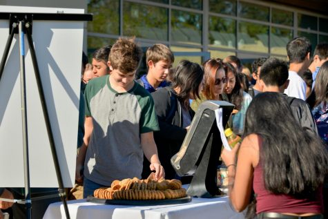 Upper school students enjoy chocolate chip cookies outside the athletics center today after school meeting. The kitchen staff prepared cookies to honor former head of school Howard Nichols birthday.