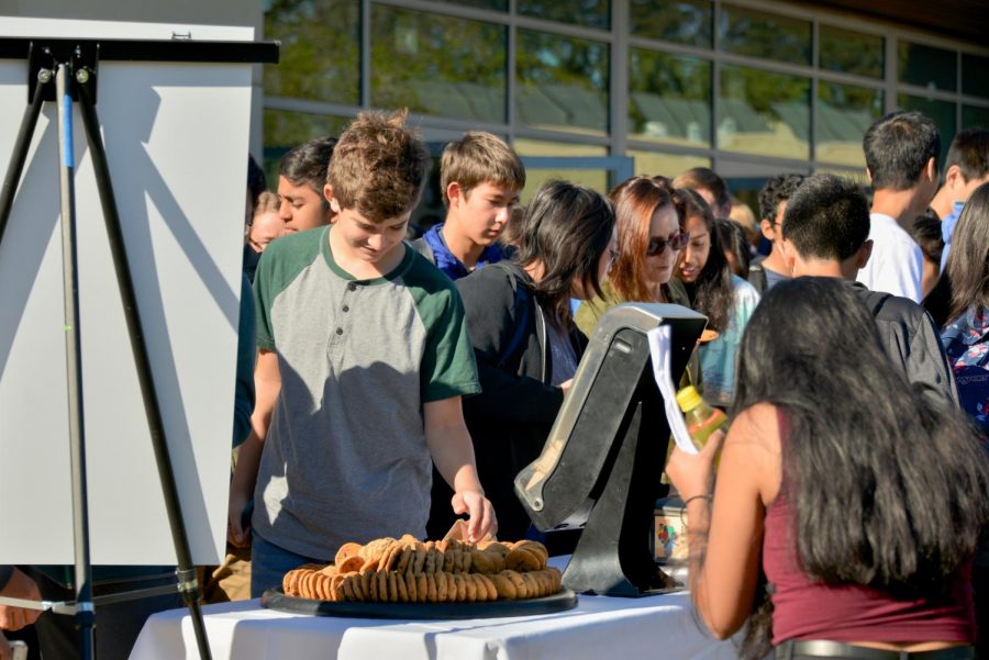 Upper+school+students+enjoy+chocolate+chip+cookies+outside+the+athletics+center+today+after+school+meeting.+The+kitchen+staff+prepared+cookies+to+honor+former+head+of+school+Howard+Nichols+birthday.