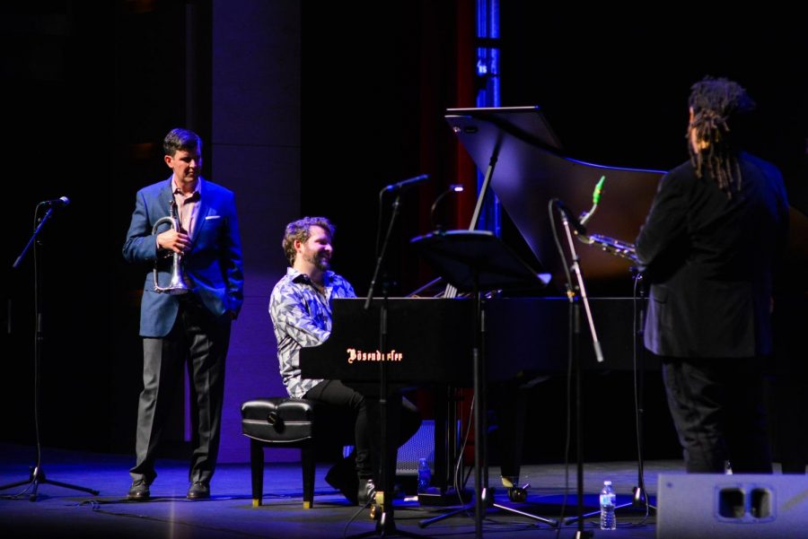 Jazz pianist Taylor Eigsti performs a solo in a piece at tonights show, which was the first performance of tonights Concert Series, as upper school music teacher Dave Hart and jazz saxophonist Dayna Stephens look on.