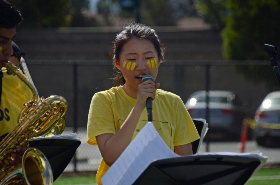 Accompanied by the jazz band, Kelsey Wu (12) sings at the end of the rally. The band played as students and teachers left for lunch.