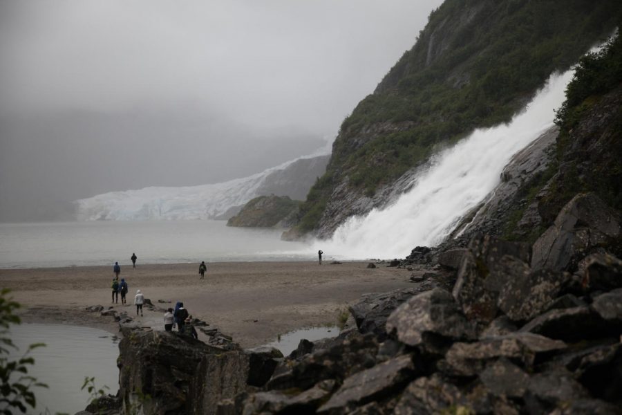 Participants in the Human Ecology: Our Place in Nature course watch tremendous volumes of water fall as a glacier melts. The students and faculty hiked down to the Mendenhall Glacier outside of Juneau as a part of their hands-on learning trip.