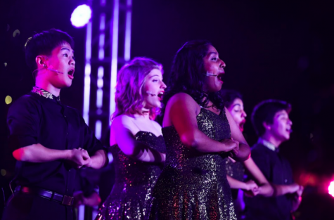 Downbeat members Neha Premkumar (12) and Kenya Aridomi (11) sing a rendition of Deck the Halls. Downbeat performed both at the pre-show and during the tree lighting ceremony.