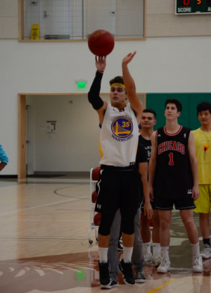Mitchell Granados (12) shoots a basketball at the Hoops and Scoops fundraising event Nov. 27. The event was hosted to fundraise for MDA. 