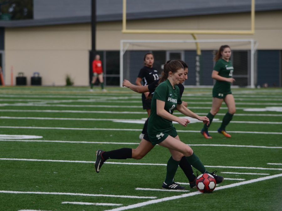 Sarah Baicher (10) fights for the ball on the sidelines against an opposing Eastside player. The girls celebrate their senior night on Feb. 5 on Davis Field at 3:30 p.m.