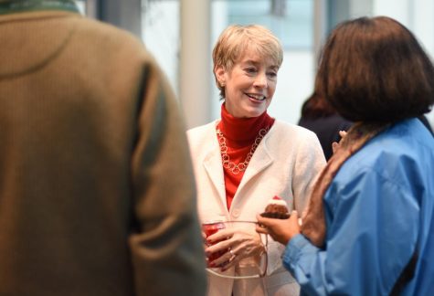 Sue Smith, who has worked as an archivist, a librarian and the K-12 Library Director at The Harker School, talks with colleagues at her retirement party this afternoon in the Nichols Rotunda.