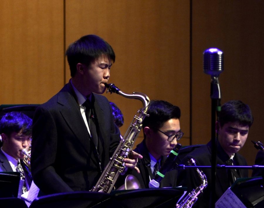 Brendan Wong (11) plays a tenor saxophone solo along with Jazz Band. The Winter Concert on Friday featured upper school students in three musical groups.