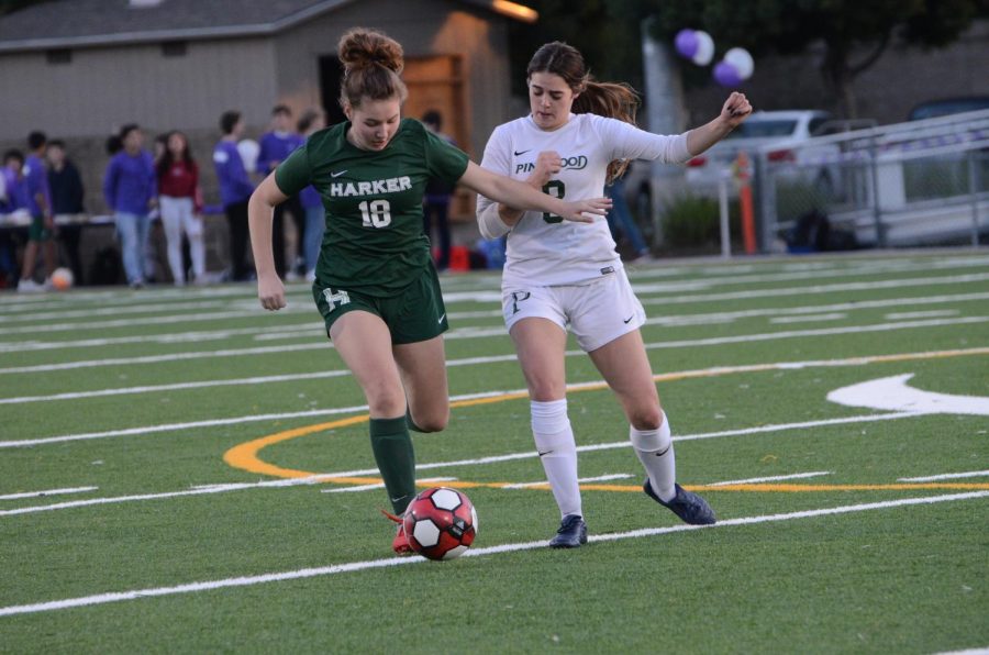 Kate Leafstrand (9) controls  the ball as a Pinewood player chases after her. The varsity girls won 5-0 against Pinewood.