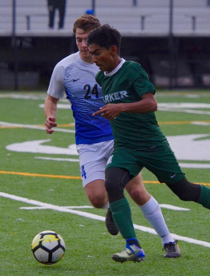 Ishaan Mantripragada (9) takes the ball downfield as a Priory player chases him. The team is on a 7-game win streak, which began with their win over San Mateo on Nov. 30.