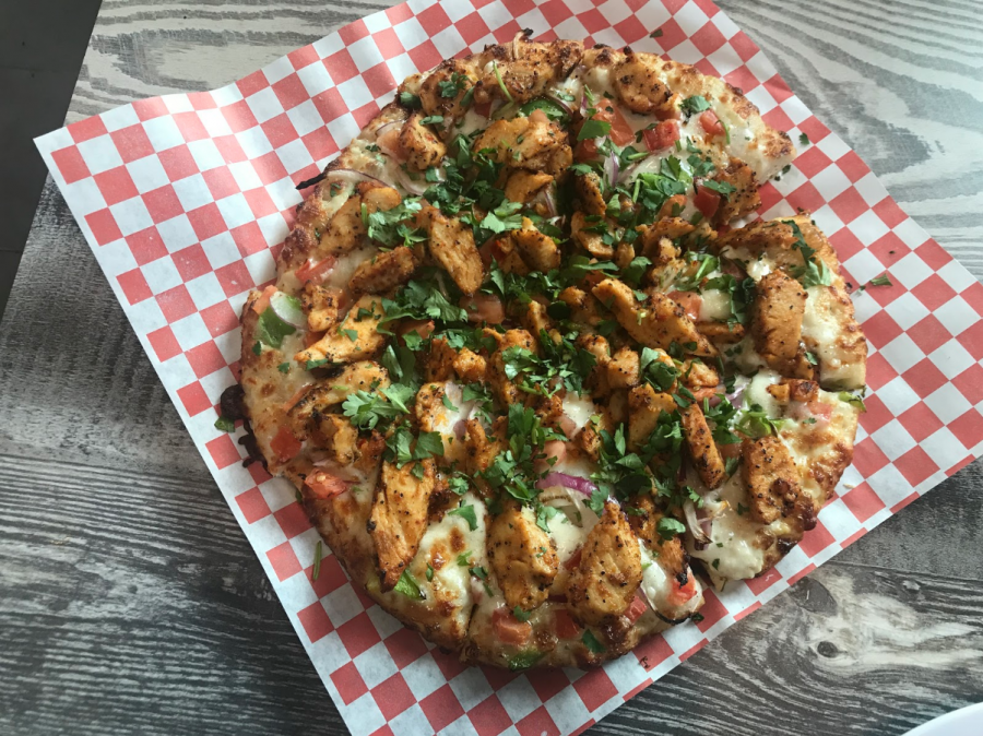 Curry Pizza House offers a variety of pizzas including this one, the Tandoori Chicken Pizza. The restaurant merges Italian and Indian cuisines to create dishes called Desi Pizzas. 
