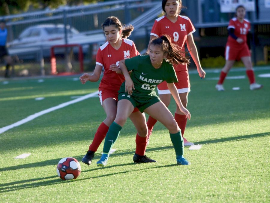 Aria Wong (10) fights to gain control over the ball against an opposing Mercy player. The girls won the game 6-1. 