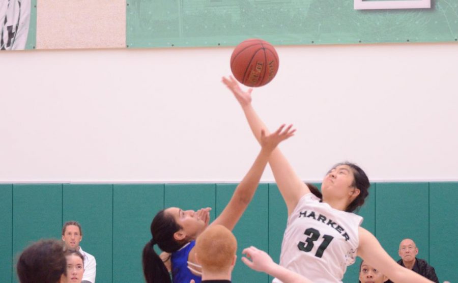 Kaitlyn Dai (11) gains possession of the ball at the jump ball at the beginning of the game. The girls play at Castilleja on Tuesday at 5:30 p.m.