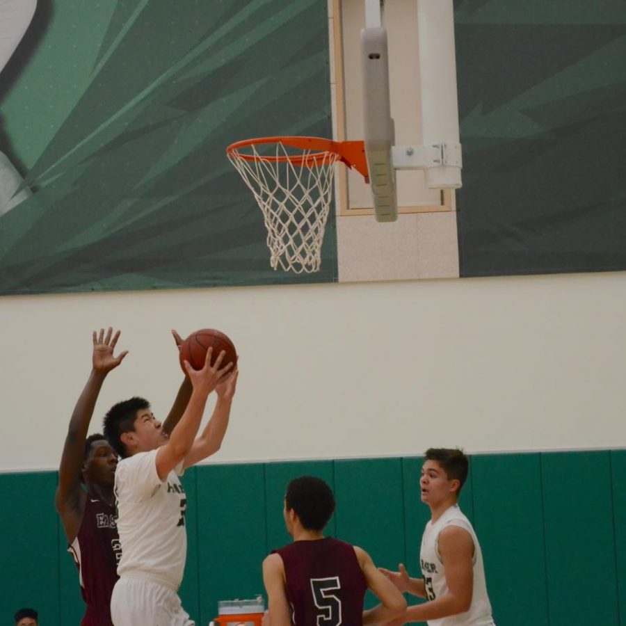 Eric Zhu (10) scores in the paint. The varsity boys face off at Menlo at 6:30 p.m. on Tuesday, and celebrate their senior night at home against Pinewood on Feb. 12. at 6:30 p.m.