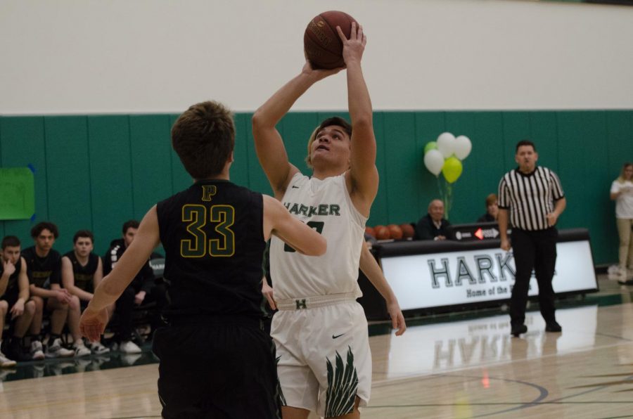 Trevor Thompson (12) attempts to score in the paint.  The varsity boys basketball team beat Pinewood 77-50 during their senior night game on Feb. 12, ending the regular season with a league record of 6-8.