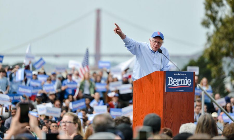 Sen. Bernie Sanders rallies supporters of his 2020 presidential bid at Great Meadow Park, gesturing at a podium against a backdrop of the Golden Gate Bridge in San Francisco. Sanders completed his California tour this afternoon, after making stops at San Diego and Los Angeles in the past weekend.