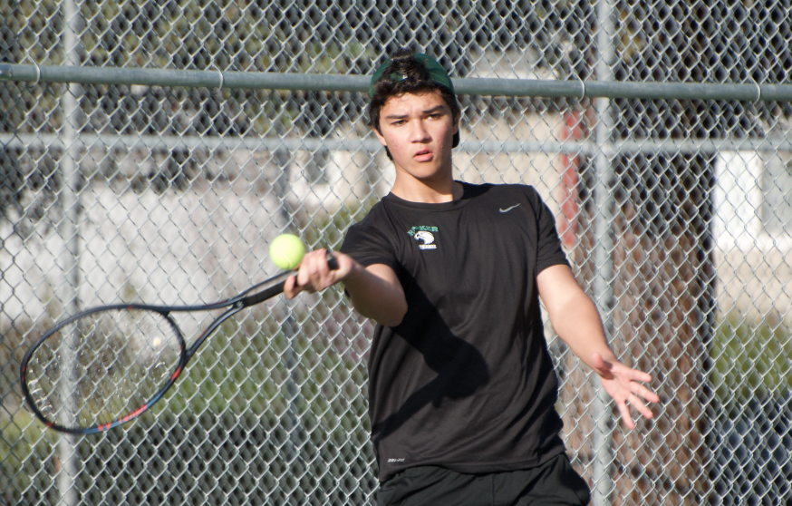 Junior Jack Hansen hits the ball during a doubles match against Menlo on Friday, Mar 8.  The boys tennis team is currently 2-1 in league, as they prepare to host King’s Academy on Mar 11 at 4:15 p.m.