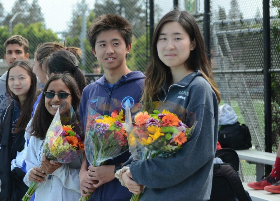 Ihita, Alex and Angela hold bouquets ahead of the meet. “This is their last event with our school, and it’s kind of sad to think about, so we’d like to end it with a joyous festival to honor all of them,” Cassandra Ruedy (11) said.