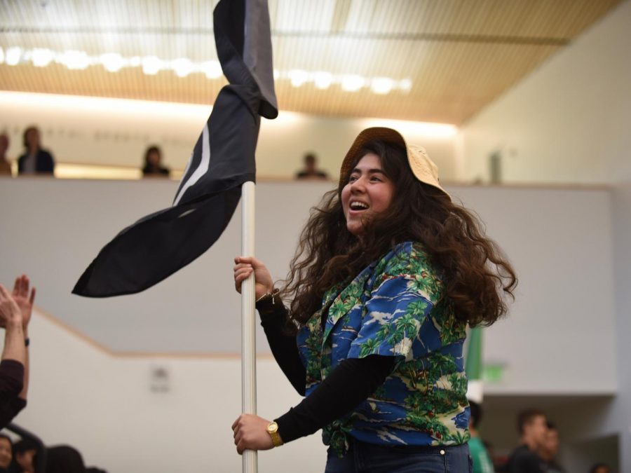 Grace Hajjar (11) waves the 2020 class flag in support of her fellow juniors. The juniors lost the volleyball game to the seniors, who went on to participate in the student-faculty volleyball game.