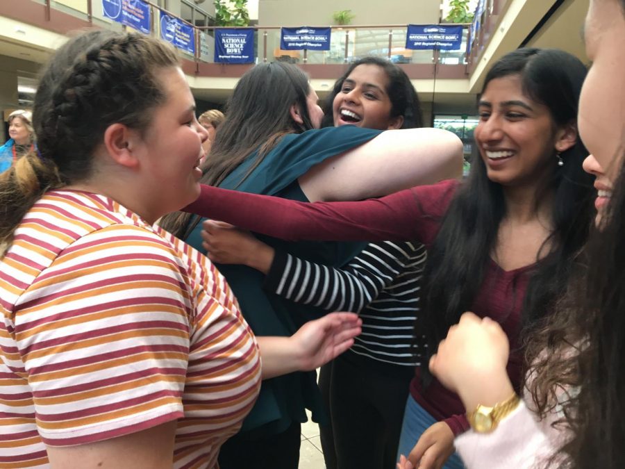 WiSTEM member Rashmi Iyer (11) reaches out to hug a visiting student from New Zealand as they exchange their goodbyes at the end of the day. 