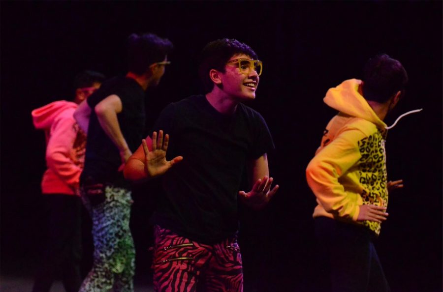 Joel Morel (11) grins at the audience as he dances in perfect coordination with his fellow members of Kinetic Krew. Kinetic Krew, 
an all-boys group directed by Rachelle Haun, features dancers from 9th to 12th grade. 
