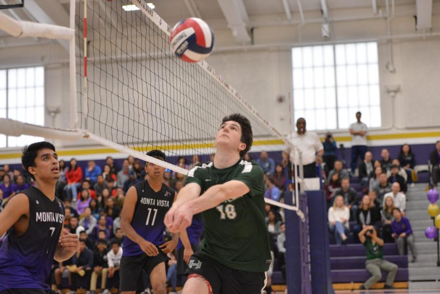 Charlie Molin (12) saves a ball near the net during the third set, which the Eagles won 25-19 to give them a 2-1 lead in the match. 