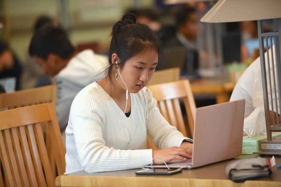 Audrey Liu (10) focuses concentratedly on her work in the library during AP week. AP Exams were help in both the Auxiliary Gym and Nichols Atrium. 