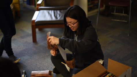 Meilin Yen (10) cuts some wrapping paper. 