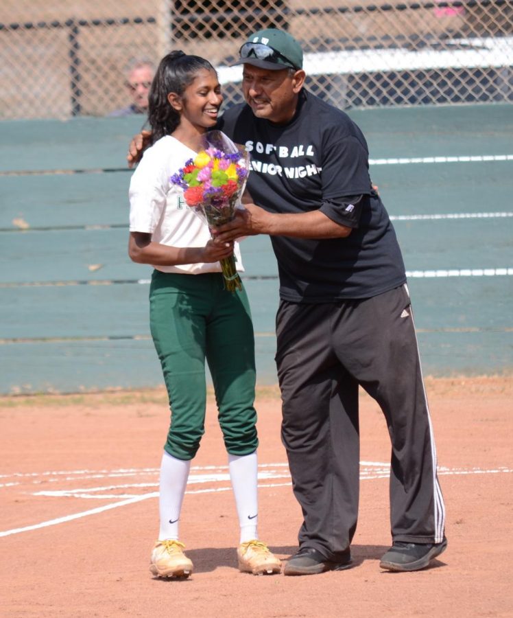 Anika Rajamani (12) receives a bouquet from coach Raul Rios ahead of the game. The girls won the game 23-22. 