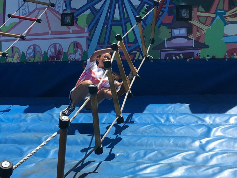 Angela Gao (9) tries to maintain her balance on a ladder course. “I was really unsure about roller coasters last year,” she said. “This time, I went on Railblazer, and it was super fun.”