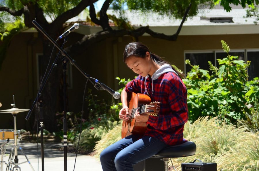 Teresa Cai (9) plays the guitar during the annual Quadchella. Both students and faculty performed at the event. 