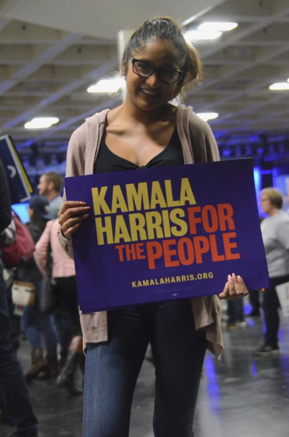 Meghna Phalke (’19) poses with a Kamala Harris poster during the afternoon General Assembly on Saturday. “Students are the generation that are up and coming; we are the generation that is going to make the difference,” Meghna said.