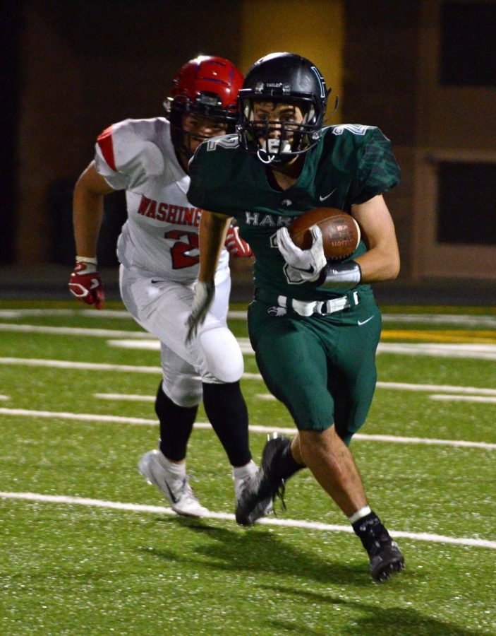 Runningback Devin Keller (12) rushes during the third quarter. Devin scored Harkers first points of the game when he ran for a 30-yard touchdown in the second quarter. 
