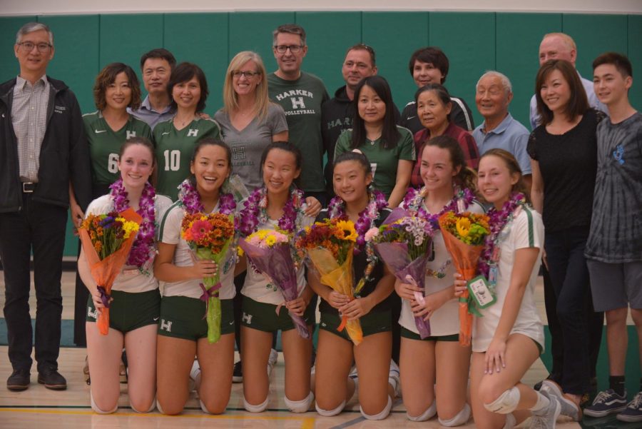 The seniors of the varsity volleyball team pose together with their families after the ceremony. This will be the girls last home game this season, as they move on to compete in playoffs.