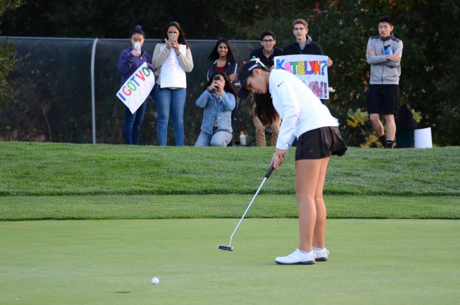 Katelyn Vo (12) watches the ball roll slowly across the green toward the last hole of the match. The only senior on the team, she was honored in the senior night ceremony following the match.