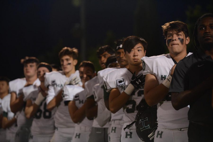 Members of the football team line up for the signing of "The Star-Spangled Banner". 