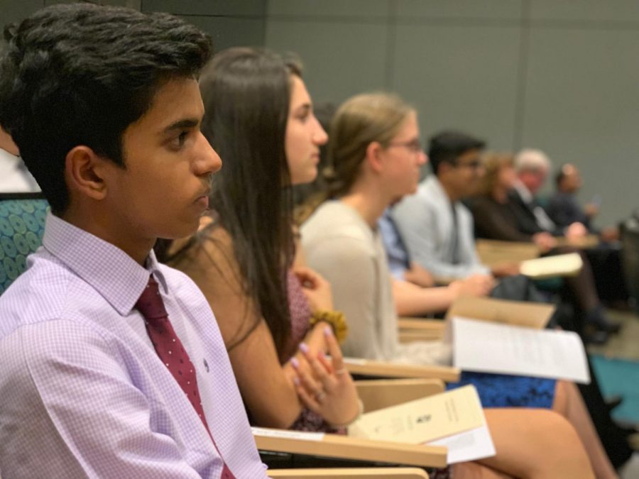 Dhruv Saoji (10) listens as upper school head Butch Keller delivers a speech to the newly-inducted NHS members.