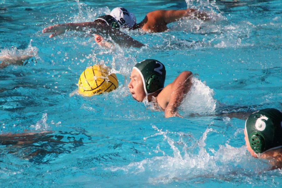 Evan Zau (10) swims down the pool with the ball during the junior varsity game against Fremont High School on Sept. 12. The Eagles beat Fremont and maintain a 7-1 record.