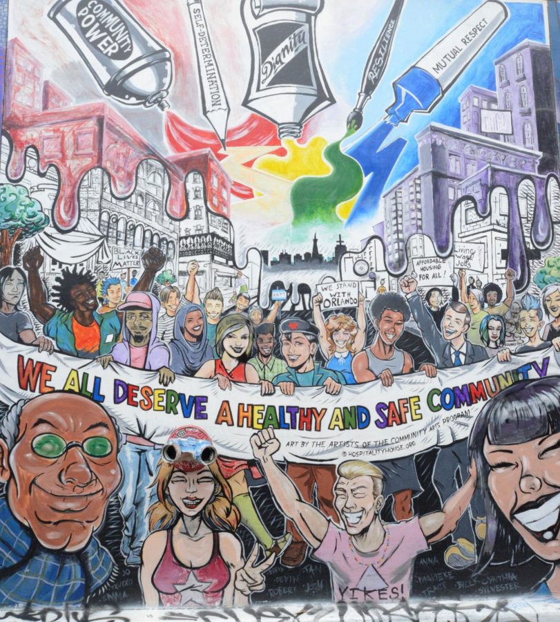 A mural by the group Hospitality House features a crowd of people of varied age and racial background holding a rainbow sign advocating for a healthy and safe community. The alley hosts a total of 700 murals, according to the project’s website.
