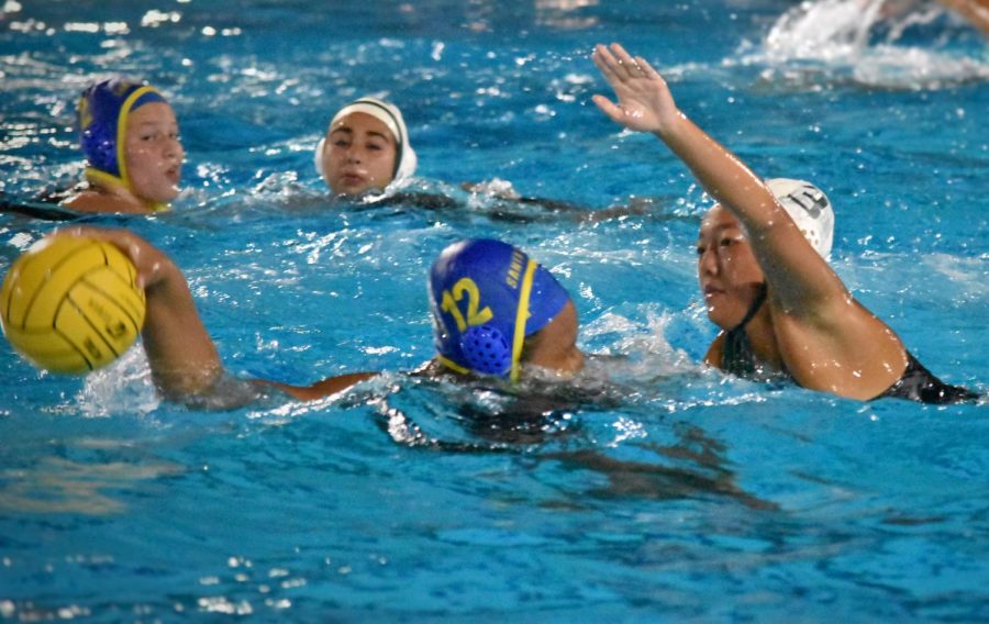 Co-captain Alicia Xu (12) tries to block an opposing player from blocking the ball. The girls are currently applying for an at-large bid to earn a place at CCS, since they did not qualify at the league tournament. 