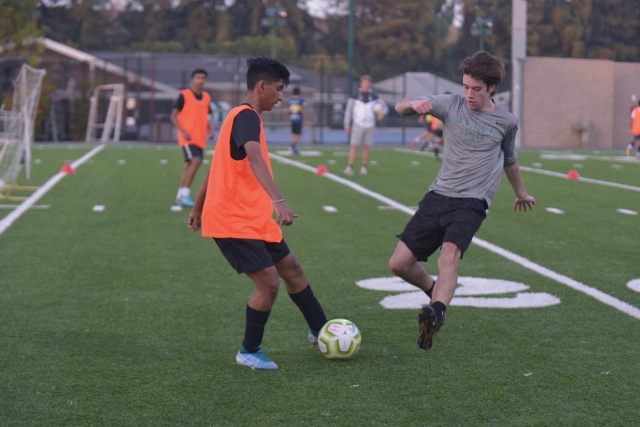 Senior Asmit Kumar evades a steal attempt by Ryan Tobin (11) during 
practice. There are three boys soccer teams this year.
