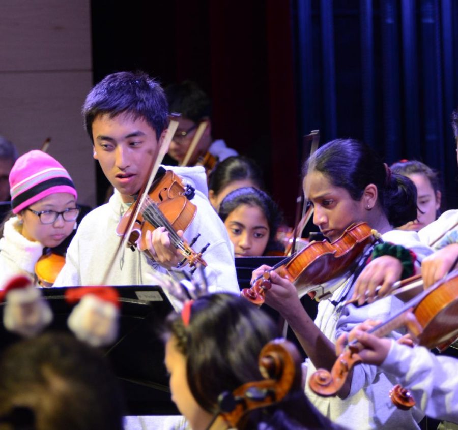 Violinists Gabriel Yang (11) and Arushi Nety (12) perform as a part of the opening set by the upper school orchestra. "I love how orchestra brings the instrumental aspect of music to BAD day, and I love performing with orchestra because it’s the biggest ensemble in the entire school," said Rishab Parthasarathy (10).