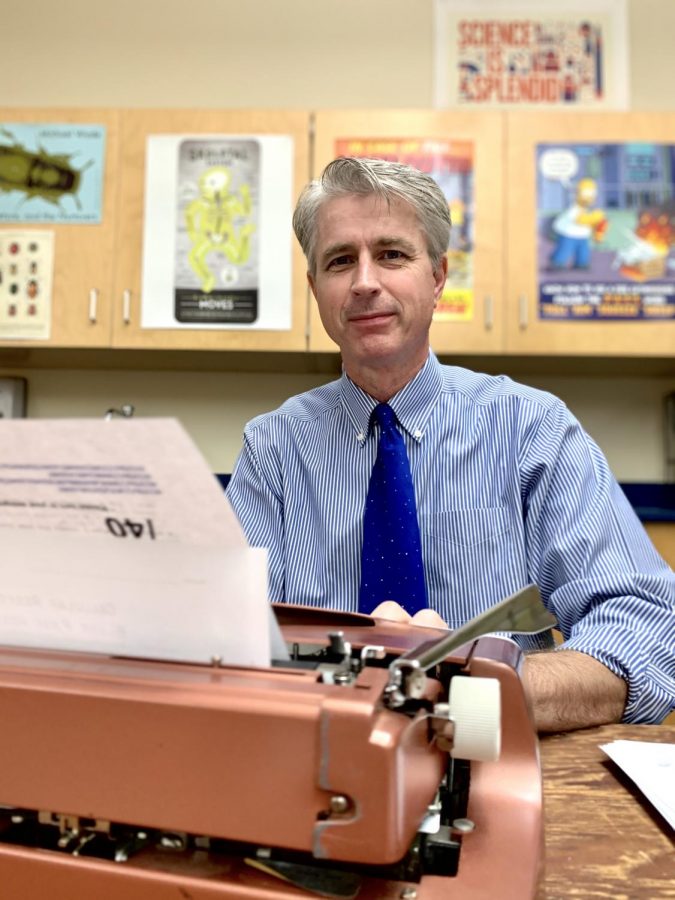 Biology teacher Thomas Artiss, at a thrifted typewriter that he brought to his classroom for students to experiment with. In his Heart of Harker guest column, Artiss responds to the newly popularized phrase "OK Boomer."