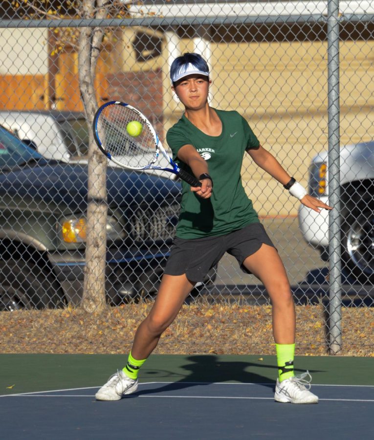 Gina Partridge (12) swings at the ball during a match. The girls tennis team reached CCS semifinals after major upsets against Cupertino and Menlo-Atherton High Schools.