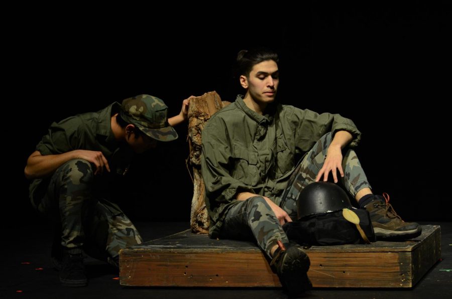 Peter Galen, played by Alex Kumar (11) in Booby Trap leans against a piece of wood as he ponders his fate and reflects upon his past. Another soldier, acted by Shray Alag (11), examines the area surrounding him.