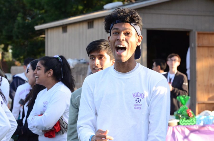 Varsity boys soccer player Shomrik Mondal (12) cheers after Mir Bahri (9) scores the JV boys' only goal of the game.