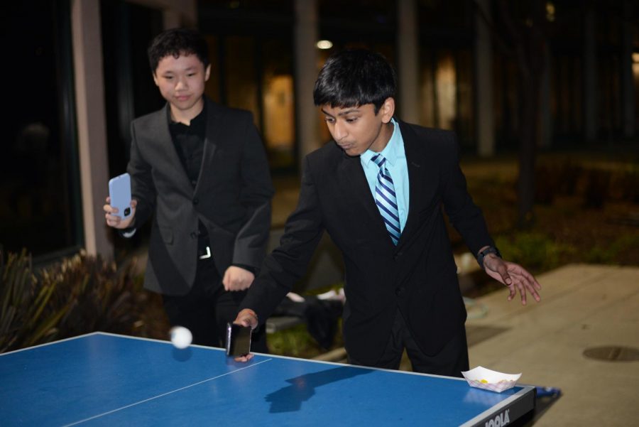 ---- and William Chien (10) play ping pong at the dance, using their phones as rackets.