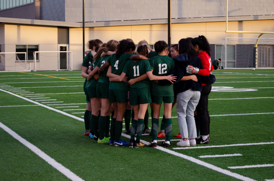 The varsity girls soccer team huddles up before a game on Friday. “Were pretty close, and we can make fun of each other and not really get offended,” Divya Sivakumar (9), a player on the team, said, adding that she would not have met so many new people if it weren’t for the team.