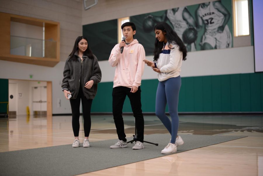 TALON yearbook editors-in-chief Emily Chen (12) and Anthony Xu (12) and TALON managing editor Shreya Srinivasan (11) announce that all yearbooks from this year onwards will be free to all students and faculty at school meeting last Friday.