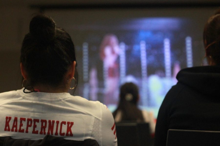 The organizer of the Super Bowl viewing party  at the Northside Branch Library, Cheryl Lee, watches Shakira perform during the halftime performance.