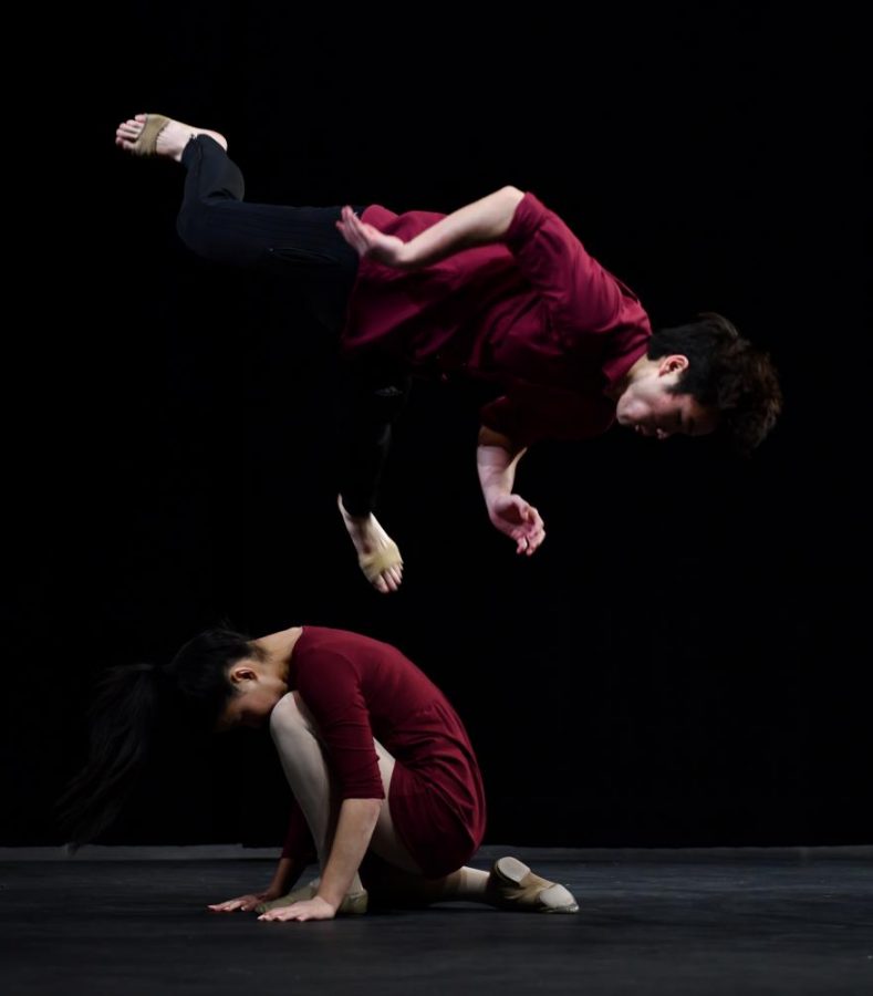 Vance Hirota (12) jumps over Chloe Chen (12) as a part of their contemporary dance to 